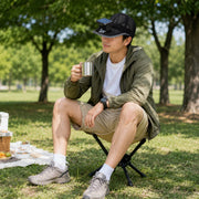Trail Natural portable folding camping stool in a park setting